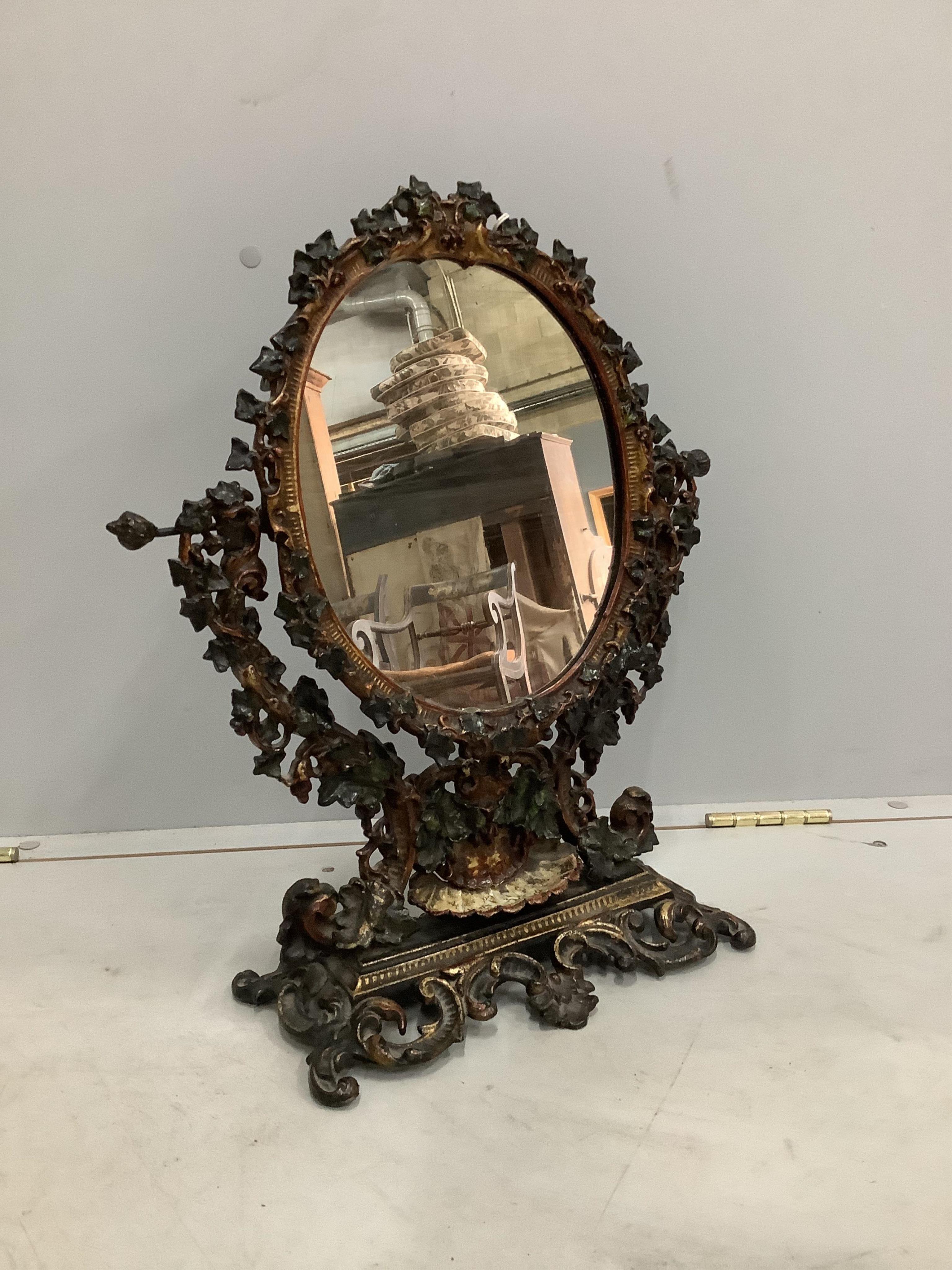 A Victorian style painted cast iron toilet mirror, width 42cm, height 50cm